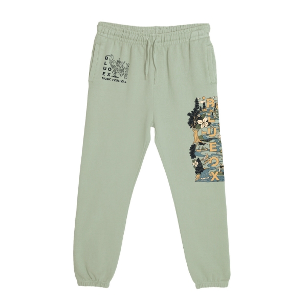 Sage green Blue Ox 2025 joggers with illustrated festival map down the right leg and heron detail on left hip
