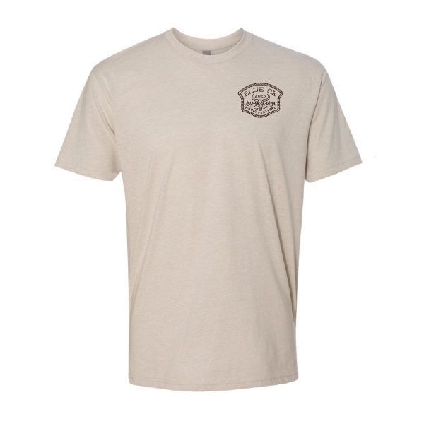 Front of Blue Ox 2025 natural t-shirt with small western-style logo patch on chest