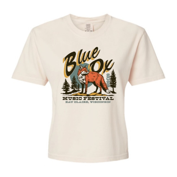Cream cropped t‑shirt featuring a fox illustration with Blue Ox Music Festival text and pine trees.