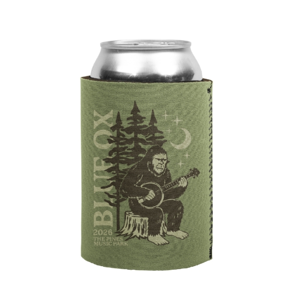 Green Blue Ox Music Festival koozie featuring a Sasquatch sitting on a tree stump playing a banjo with pine trees in the background